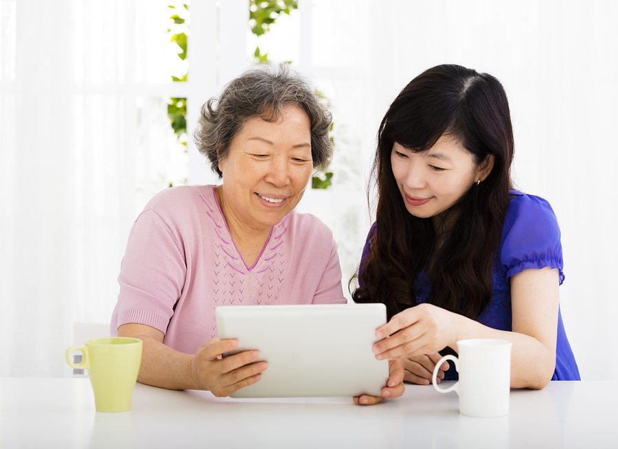 happy senior Mother and daughter learning tablet pc